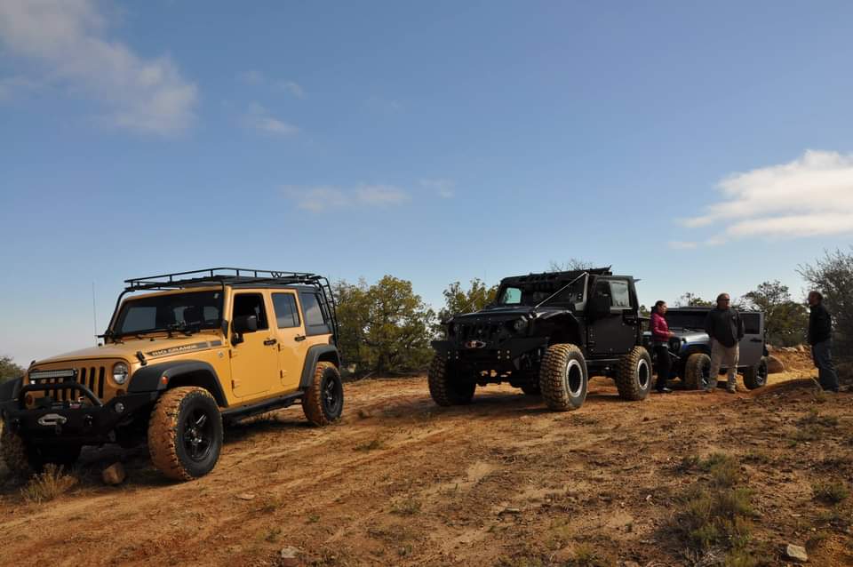 2 jeeps in open field