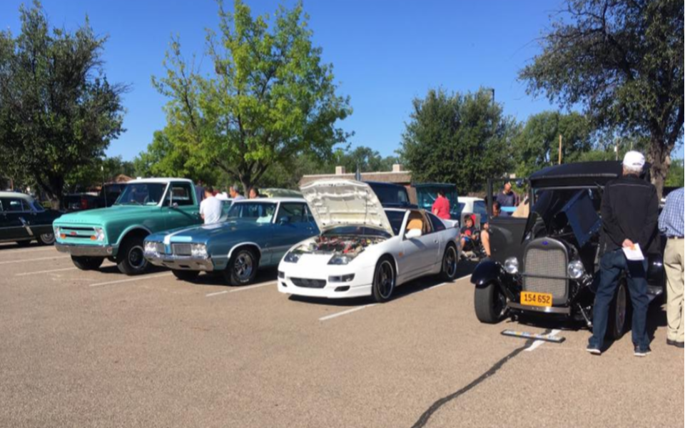 Car Show with people examining cars