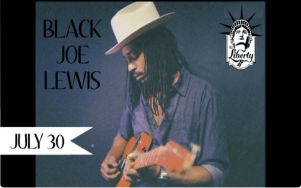 Photo of Black Joe Lewis playing guitar
