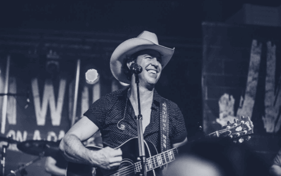 Jon Wolfe performing with his guitar