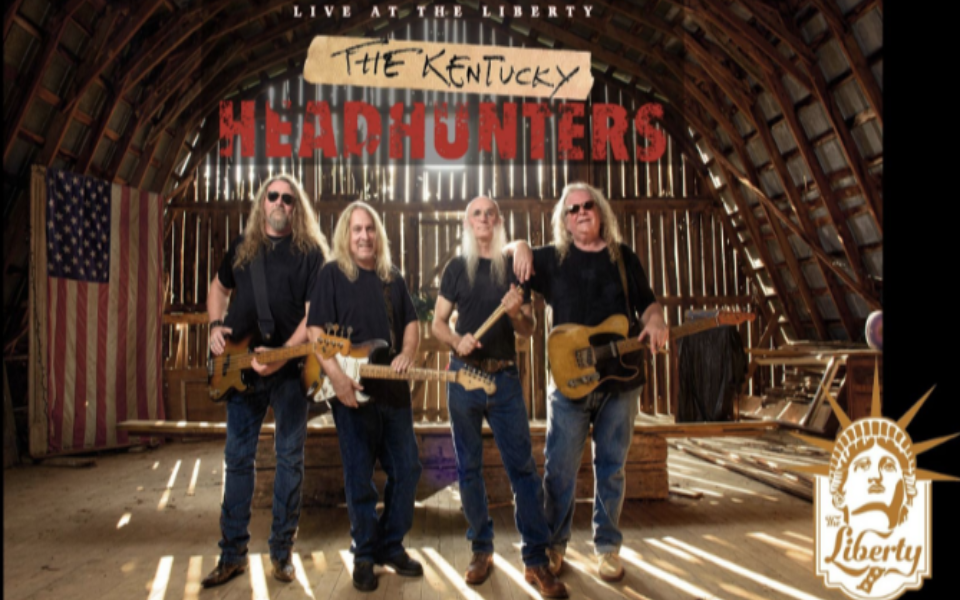 Kentucky Headhunters members standing in a barn with the light behind them